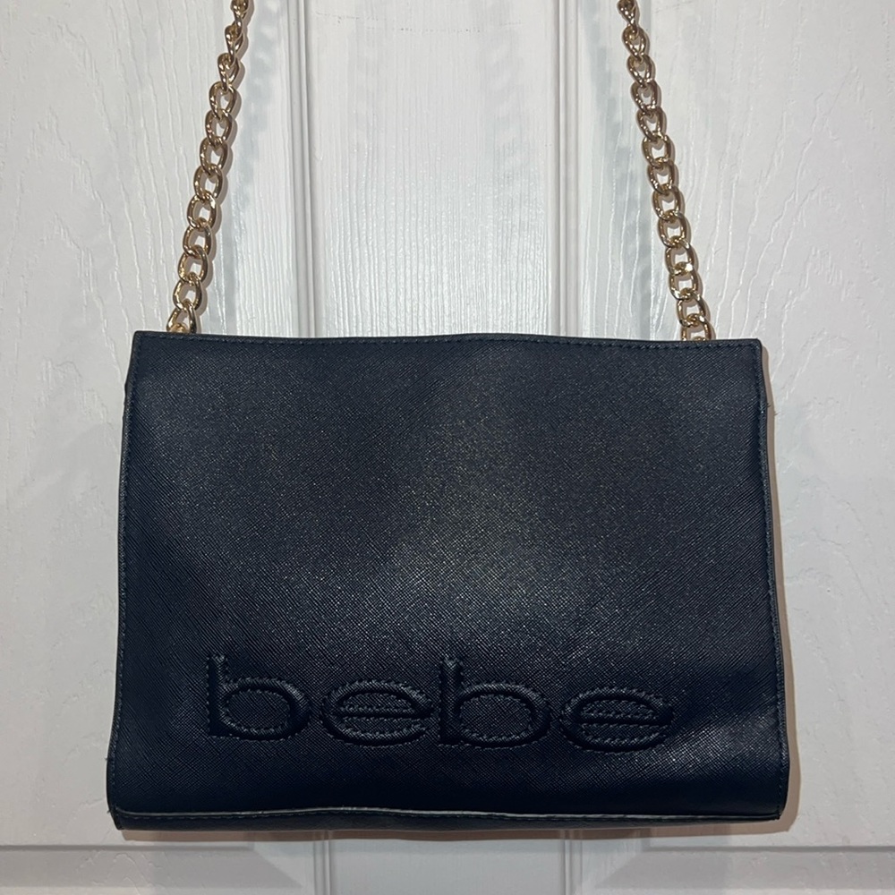 Bebe navy blue shoulder bag with gold metal strap. Like new